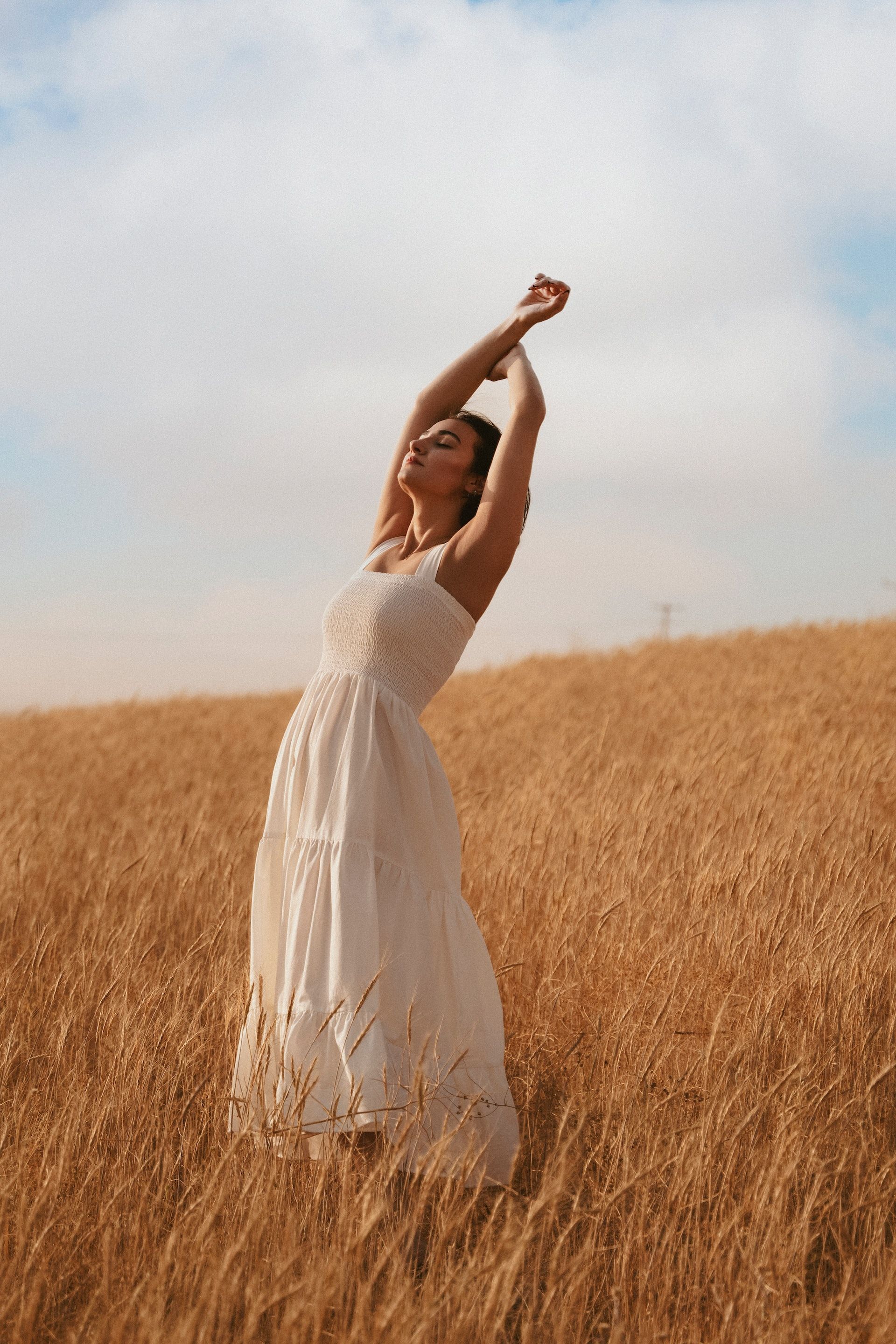 Woman with curly hair in a creative, yet simple, dress